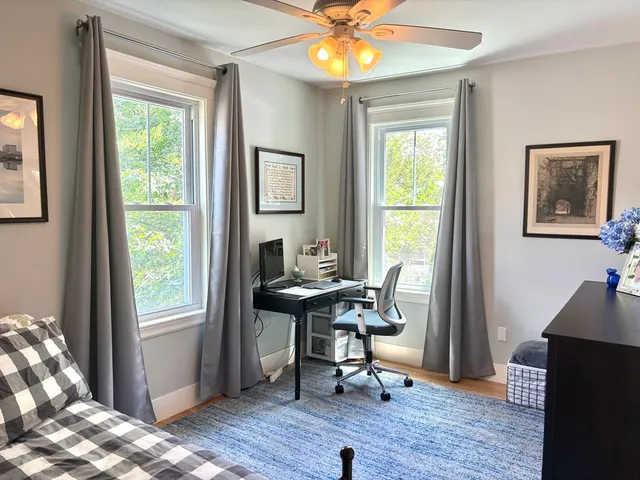 a view of a workspace with furniture and a window