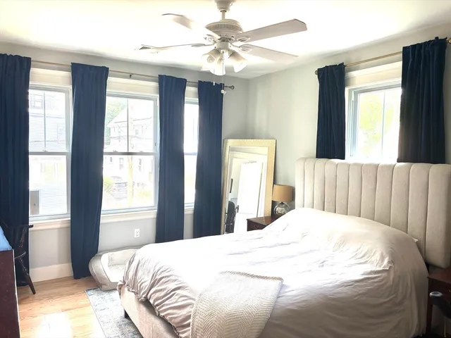 a bedroom with a large bed and a chandelier