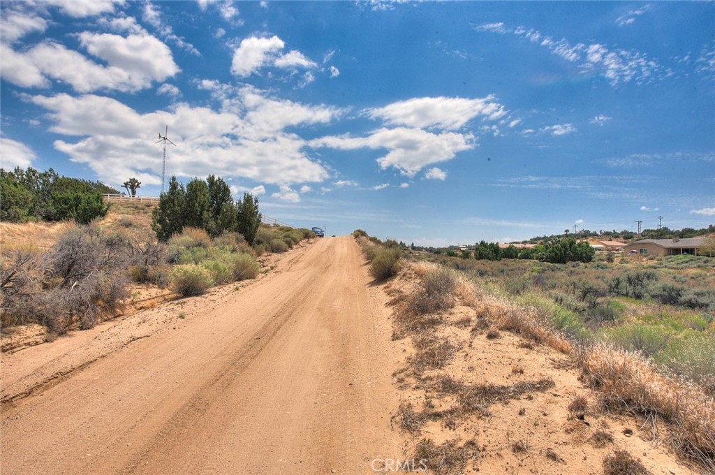 0 Verbena Road Oak Hills, CA 92344 - Photo 15 of 17 a view of a dry yard with wooden fence