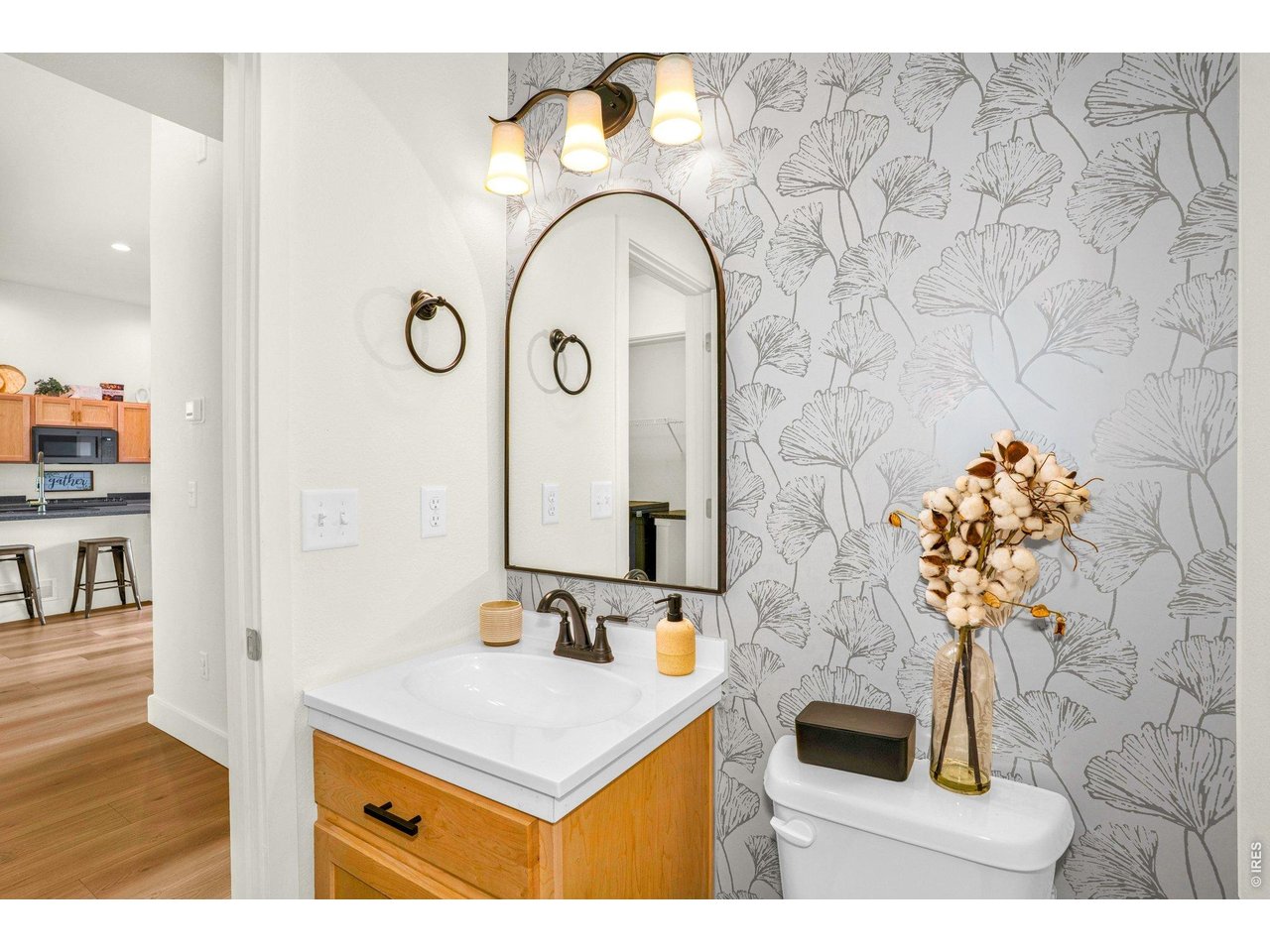934 Milner Pass Road Severance, CO 80550 - Photo 11 of 33 The main floor charming half bath makes a statement with its beautifully updated wallpaper, adding texture and personality to the space.