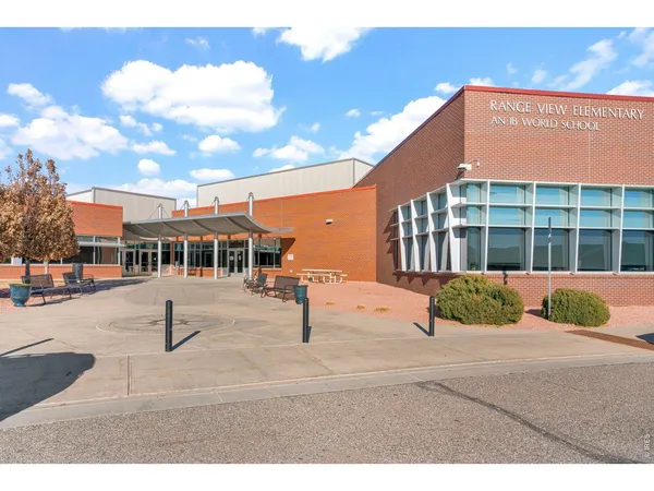 a view of a house with wooden roof and sitting space