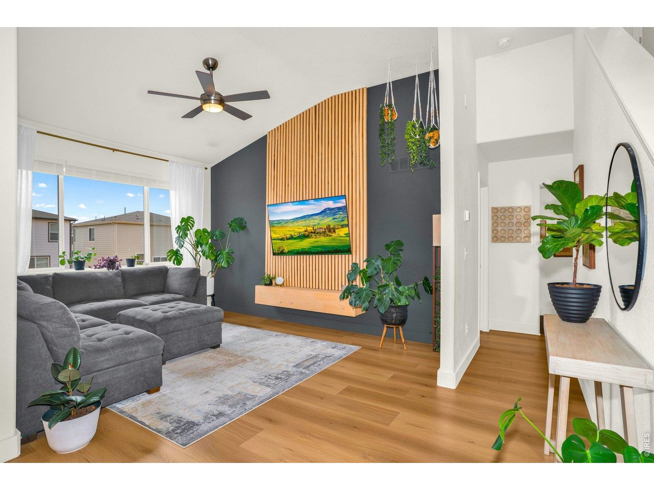 934 Milner Pass Road Severance, CO 80550 - Photo 9 of 33 The family room is anchored by a stunning wood accent wall that transforms the TV area into a true design feature.