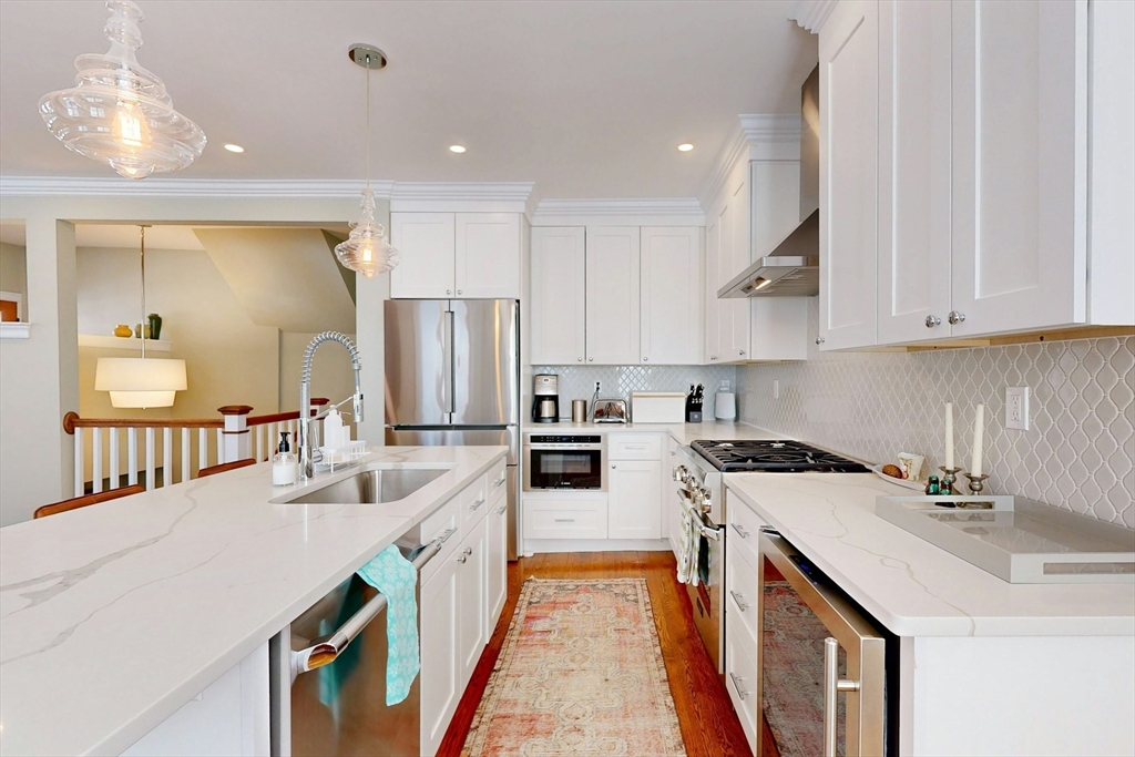 96 Floral Street, Unit 1 Newton, MA 02461 - Photo 14 of 42 a kitchen with a sink stove and cabinets