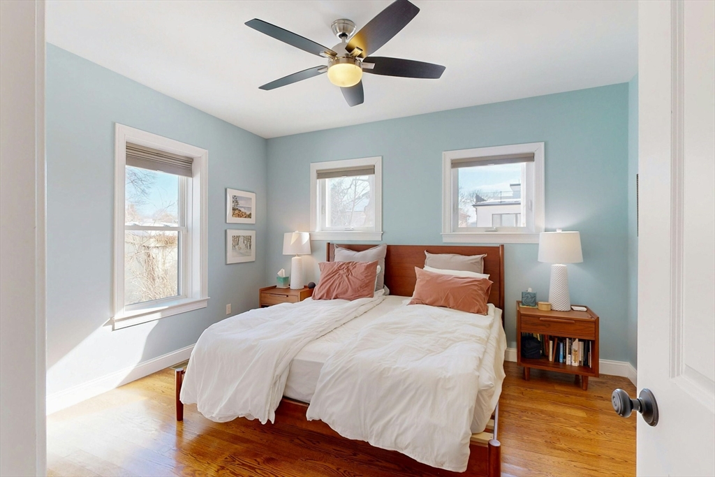 96 Floral Street, Unit 1 Newton, MA 02461 - Photo 18 of 42 a bedroom with a bed and a chandelier