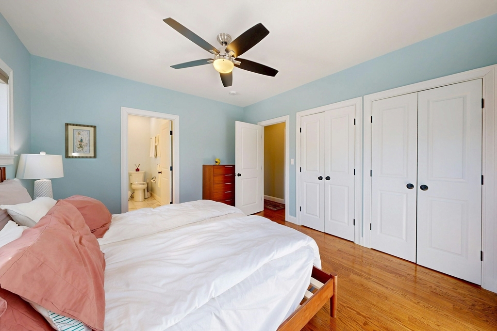 96 Floral Street, Unit 1 Newton, MA 02461 - Photo 20 of 42 a spacious bedroom with a bed and a chandelier