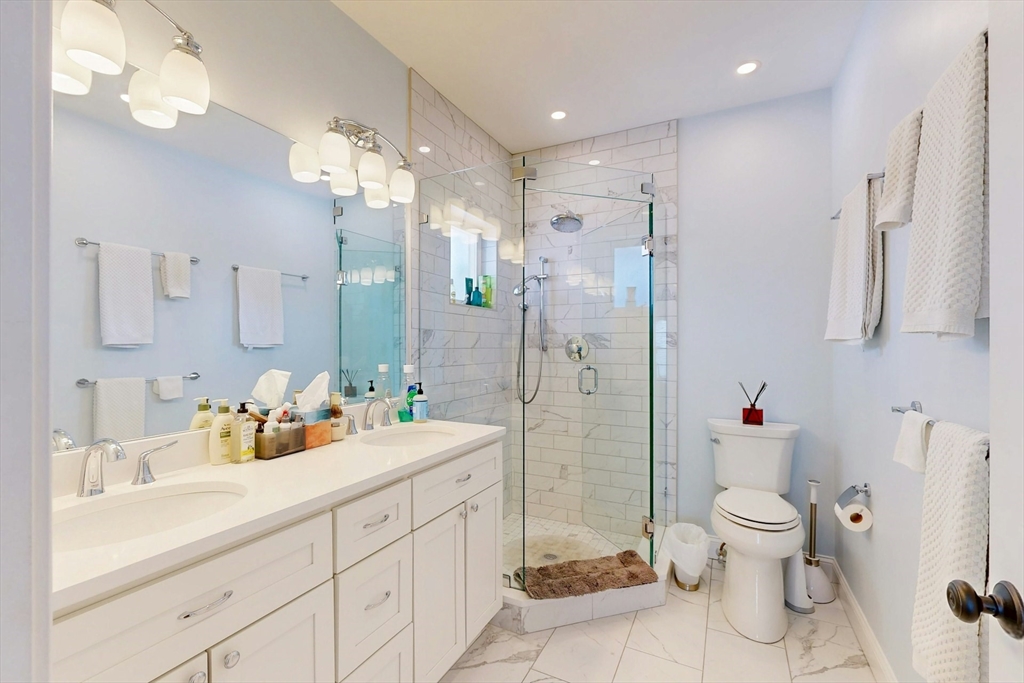 96 Floral Street, Unit 1 Newton, MA 02461 - Photo 22 of 42 a spacious bathroom with a double vanity sink mirror and toilet