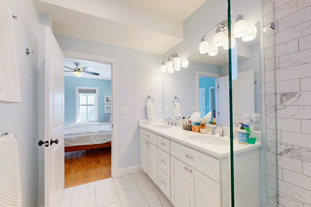 96 Floral Street, Unit 1 Newton, MA 02461 - Photo 23 of 42 a bathroom with a sink vanity and mirror