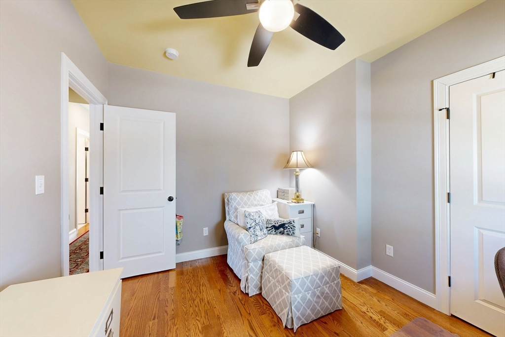 96 Floral Street, Unit 1 Newton, MA 02461 - Photo 25 of 42 a bedroom with a bed and wooden floor