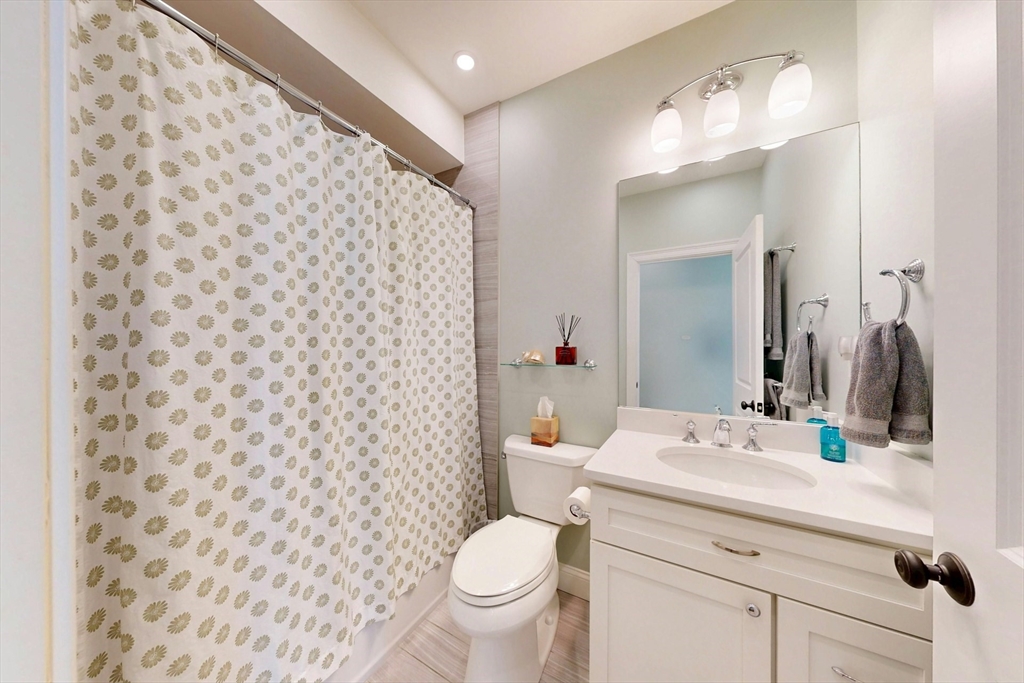 96 Floral Street, Unit 1 Newton, MA 02461 - Photo 27 of 42 a bathroom with a sink toilet and shower