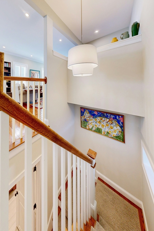 96 Floral Street, Unit 1 Newton, MA 02461 - Photo 28 of 42 a view of a hallway with wooden floor and staircase