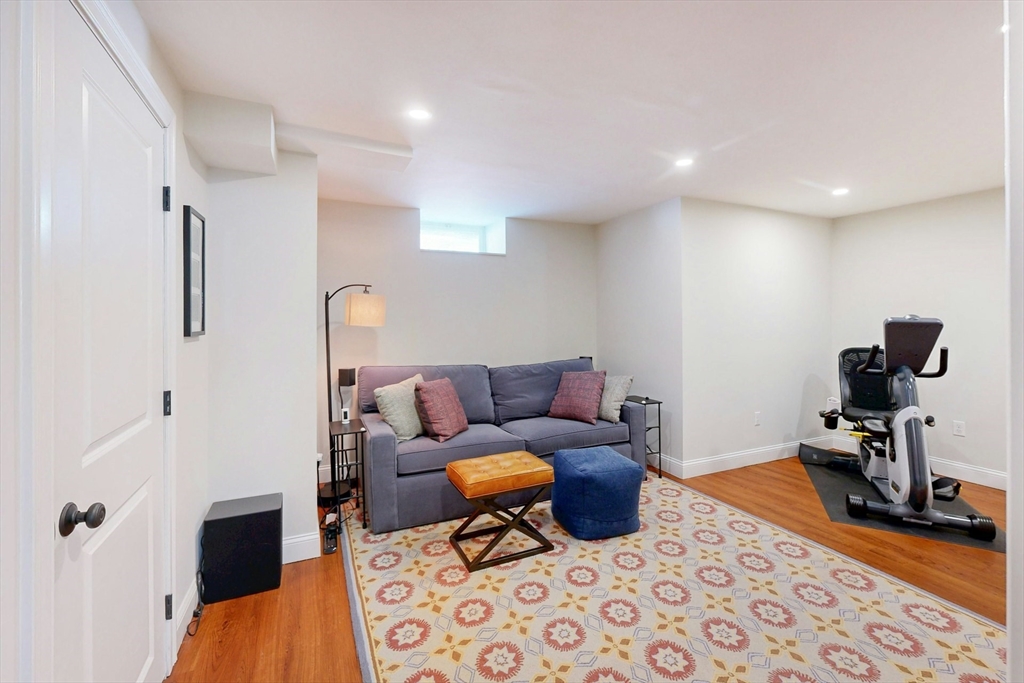 96 Floral Street, Unit 1 Newton, MA 02461 - Photo 29 of 42 a living room with furniture and a wooden floor