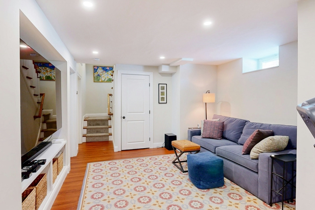 96 Floral Street, Unit 1 Newton, MA 02461 - Photo 30 of 42 a living room with furniture and a rug