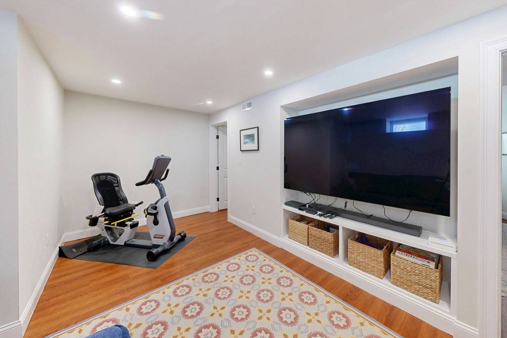96 Floral Street, Unit 1 Newton, MA 02461 - Photo 31 of 42 a living room with furniture and a flat screen tv