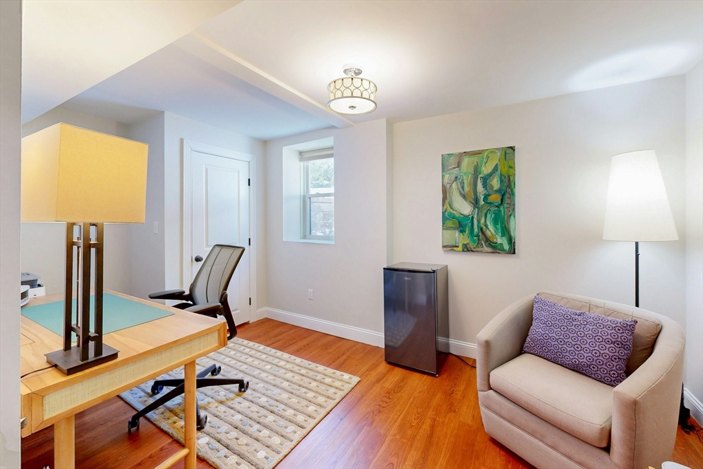 96 Floral Street, Unit 1 Newton, MA 02461 - Photo 34 of 42 a living room with furniture and a flat screen tv