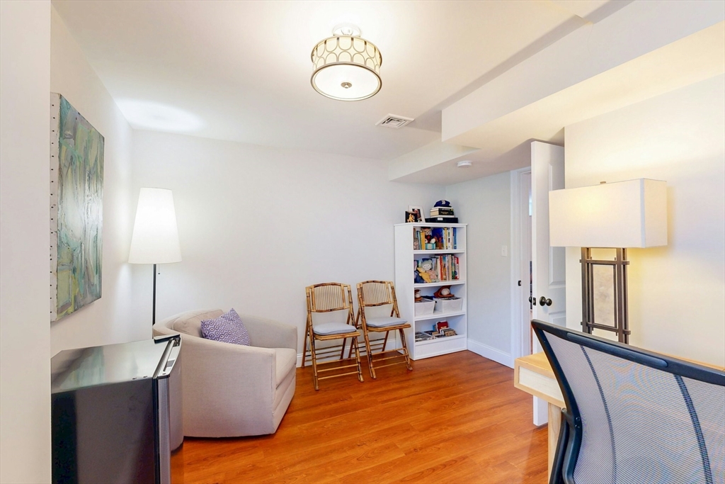 96 Floral Street, Unit 1 Newton, MA 02461 - Photo 36 of 42 a bedroom with furniture and a lamp