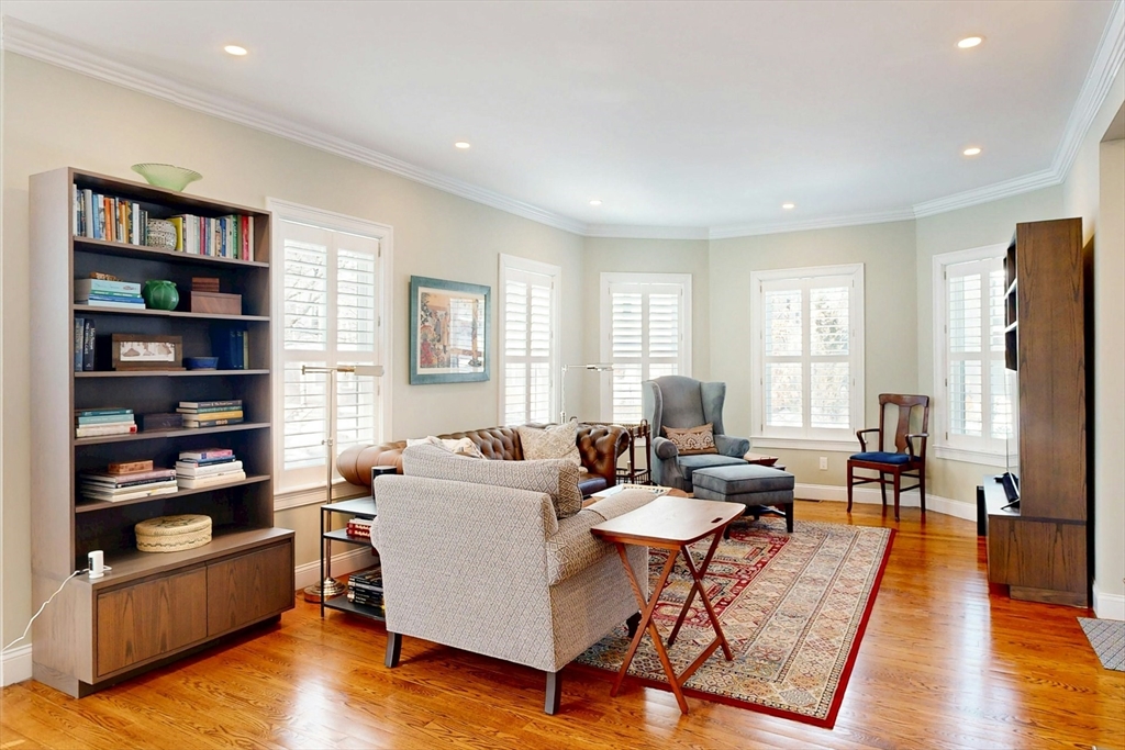 96 Floral Street, Unit 1 Newton, MA 02461 - Photo 6 of 42 a living room with fireplace furniture and a book shelf
