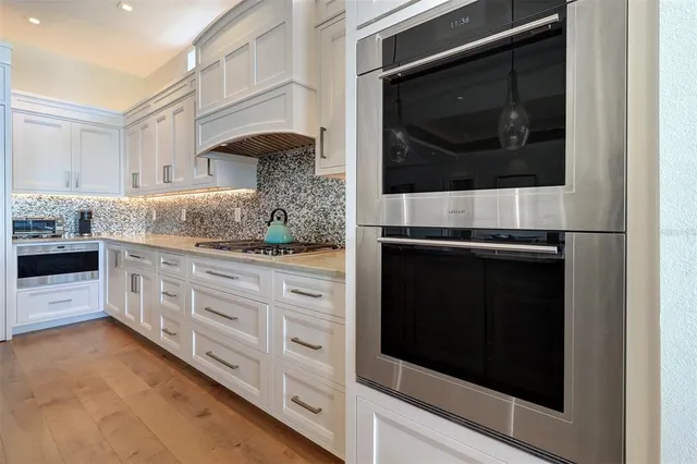 a view of hallway with wooden floor and stairs