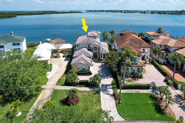 an aerial view of a house with lake view and boat