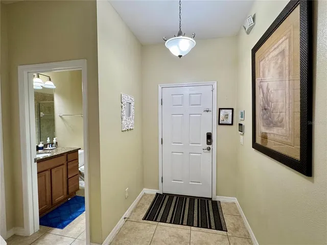 a view of a livingroom with wooden floor and a bathroom