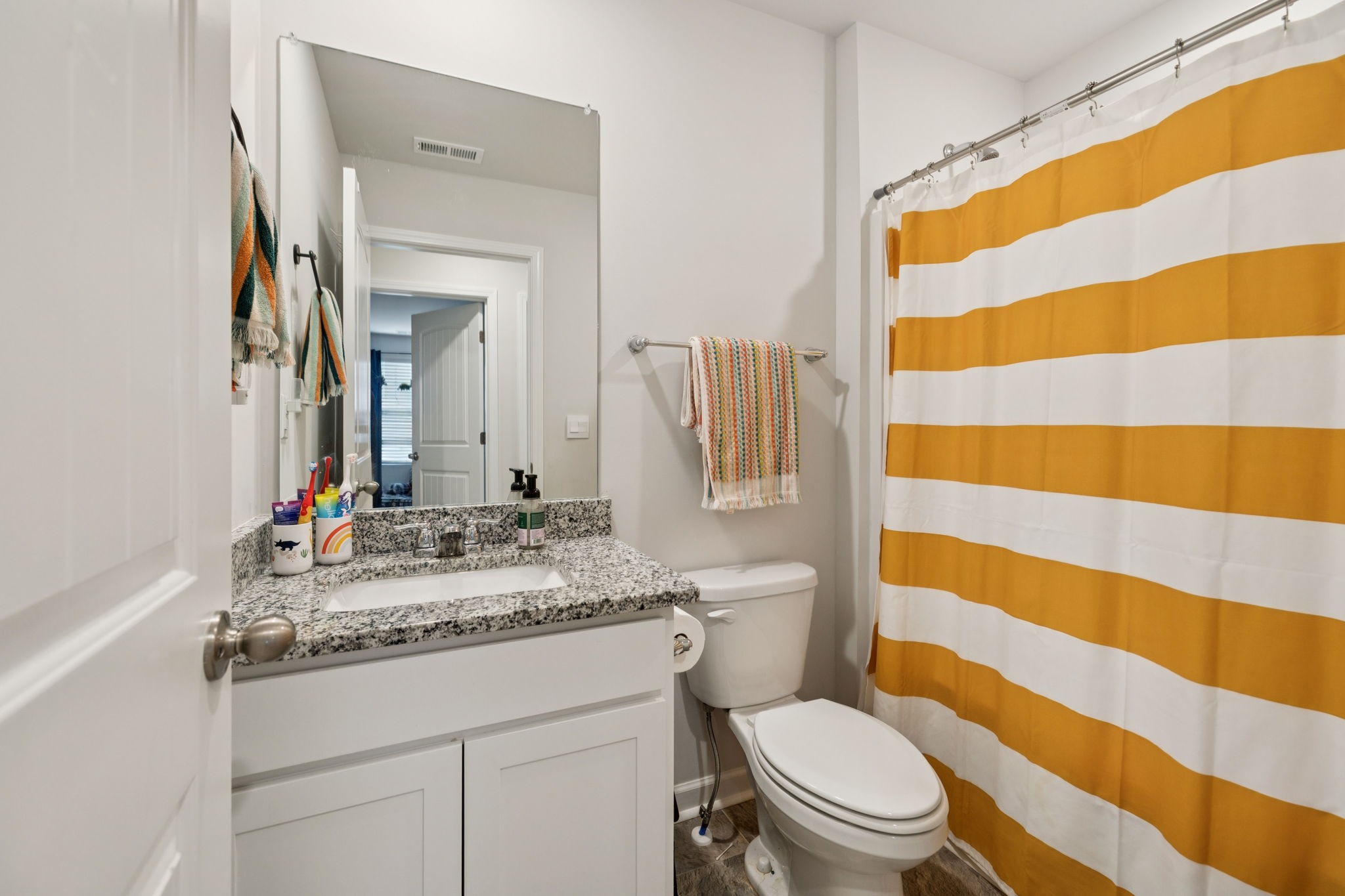 868 Long Leaf Road Lebanon, TN 37087 - Photo 21 of 40 a bathroom with a sink a toilet a mirror and shower curtain