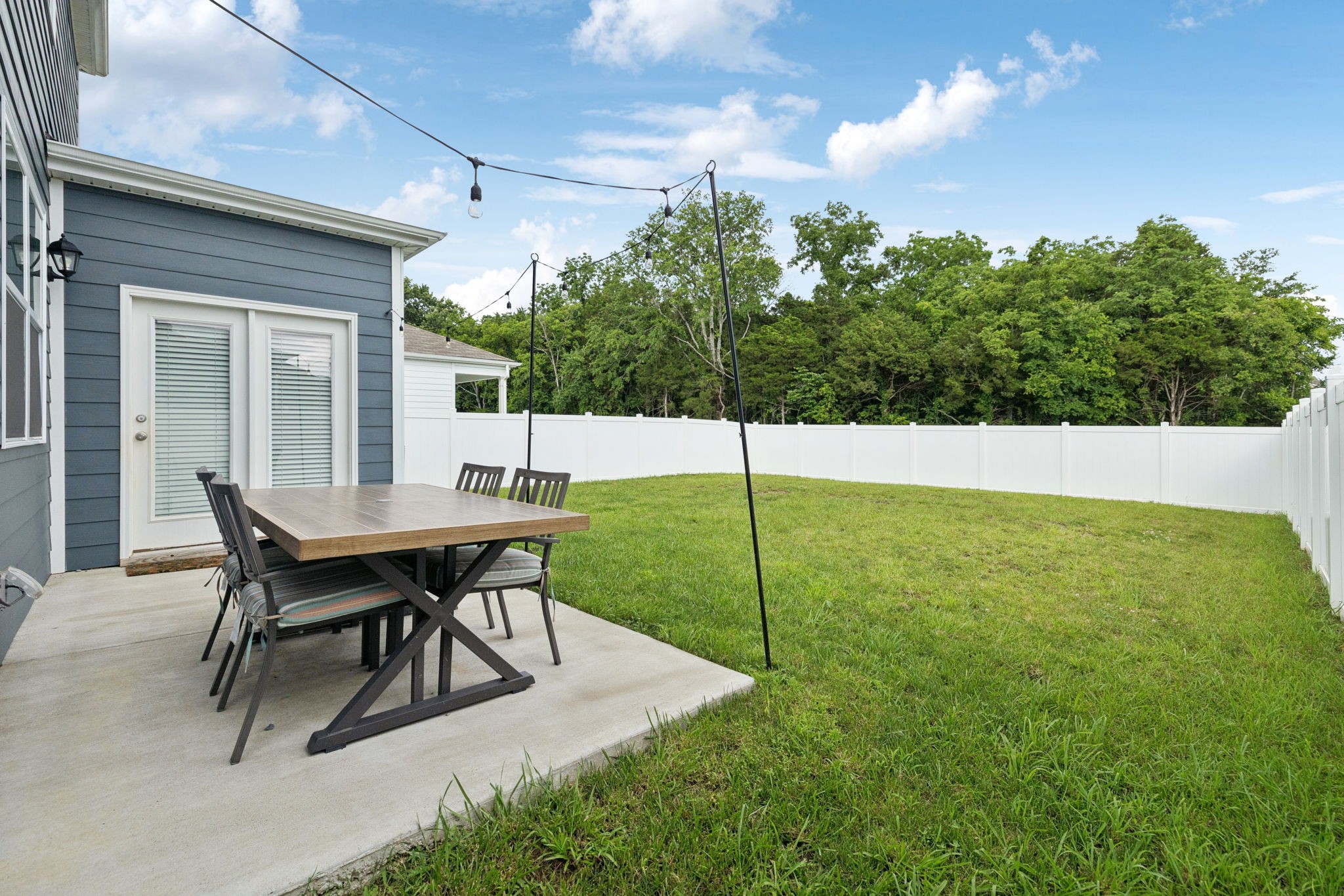 868 Long Leaf Road Lebanon, TN 37087 - Photo 31 of 40 a backyard view of a house with a garden and patio