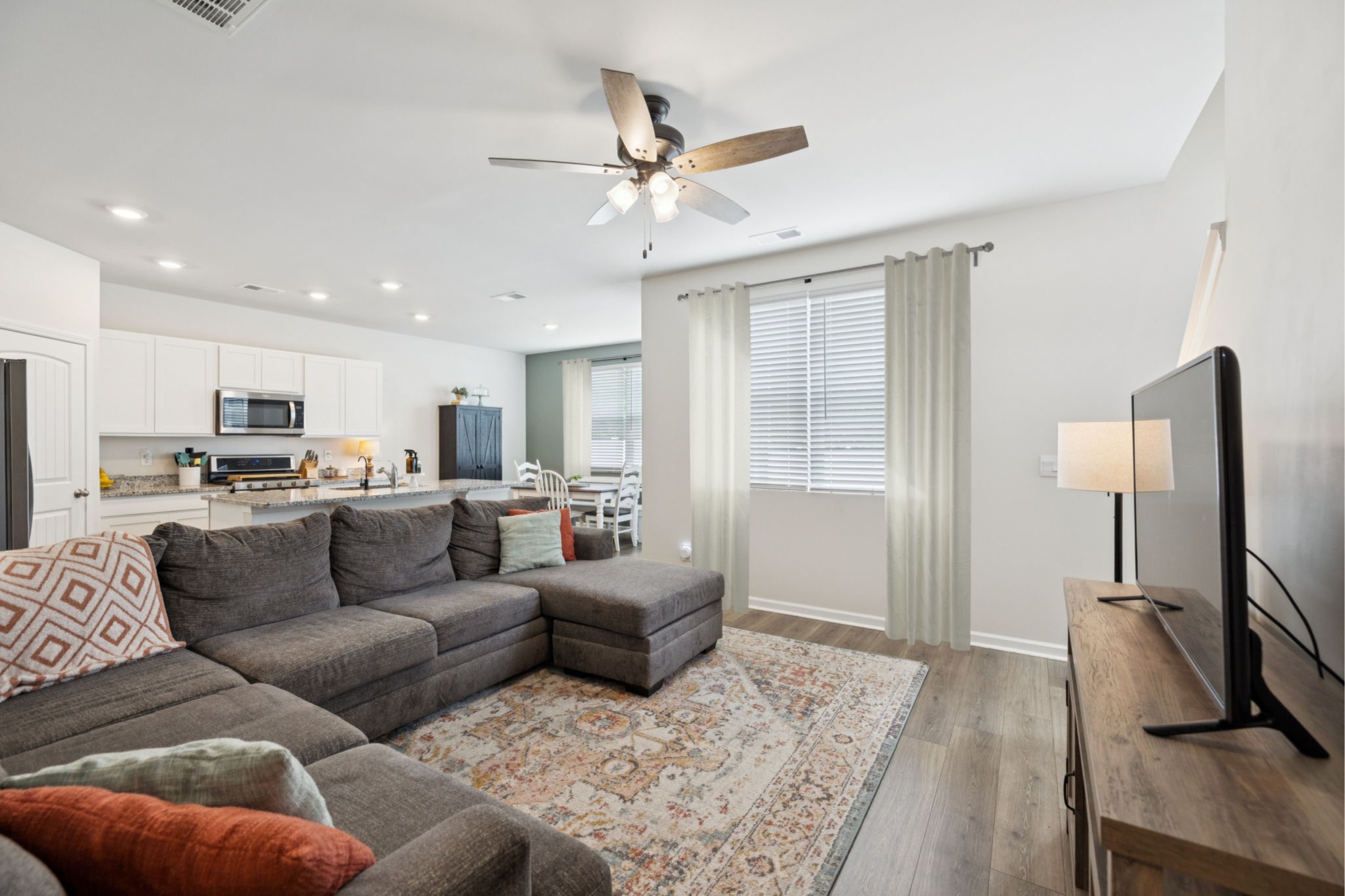 868 Long Leaf Road Lebanon, TN 37087 - Photo 6 of 40 a living room with furniture kitchen view and a flat screen tv