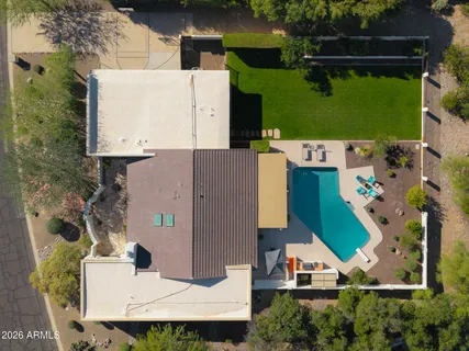 a view of a house with swimming pool and sitting area
