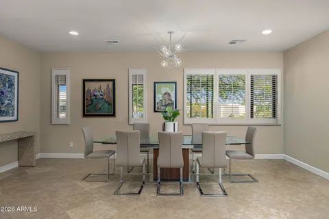 a dining room with a wooden table and chairs