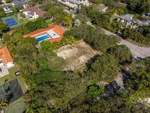 an aerial view of a house with a yard