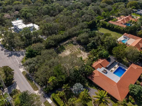 an aerial view of a house with yard and outdoor seating