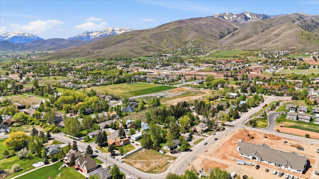 123 West 1050th North, Unit 41 Midway, UT 84049 - Photo 7 of 22 Expansive mountain scenery framing a community with residential properties and open green spaces