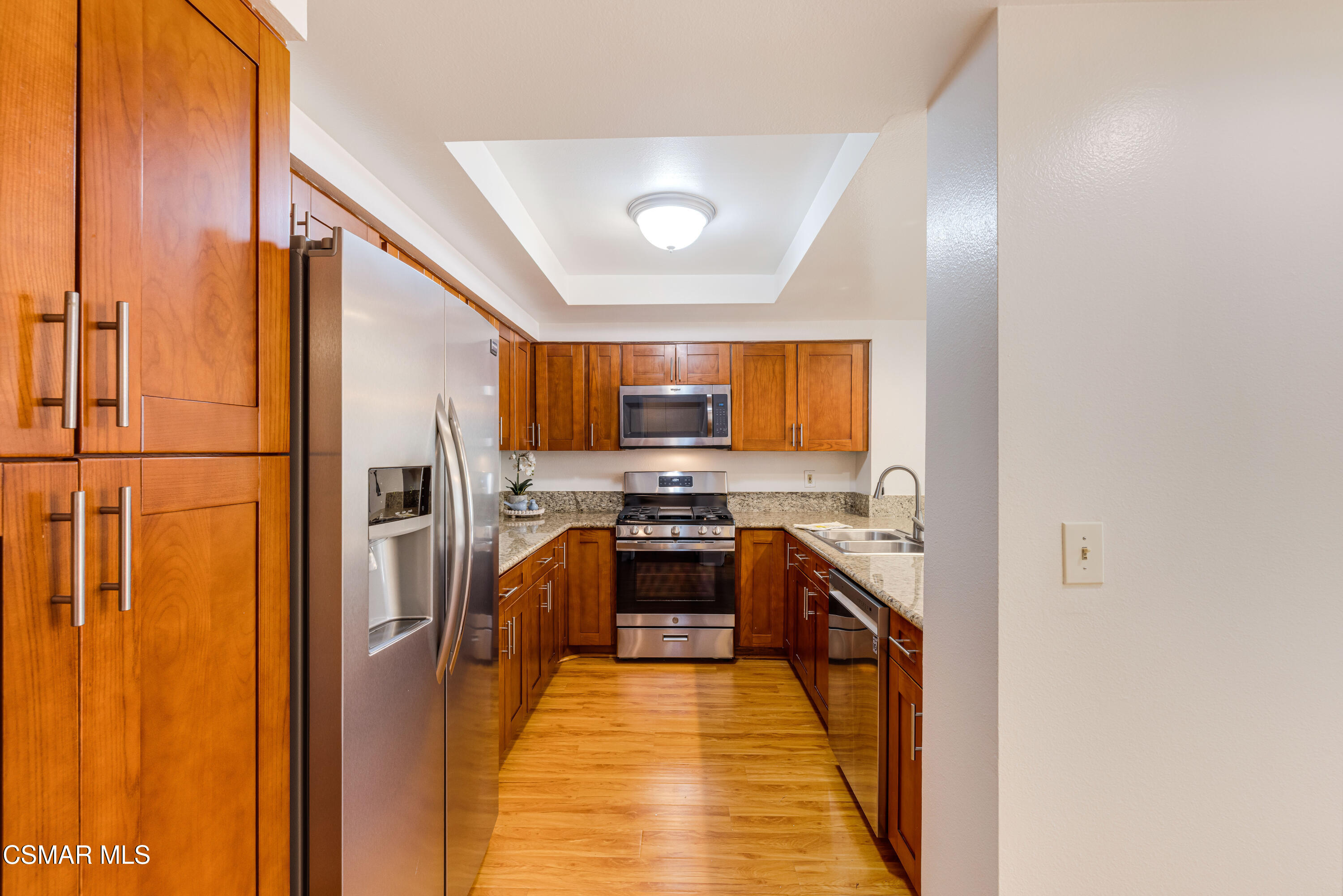 4240 Lost Hills Road, Unit 1902 Calabasas, CA 91301 - Photo 11 of 37 a kitchen with stainless steel appliances granite countertop a stove a sink and a refrigerator