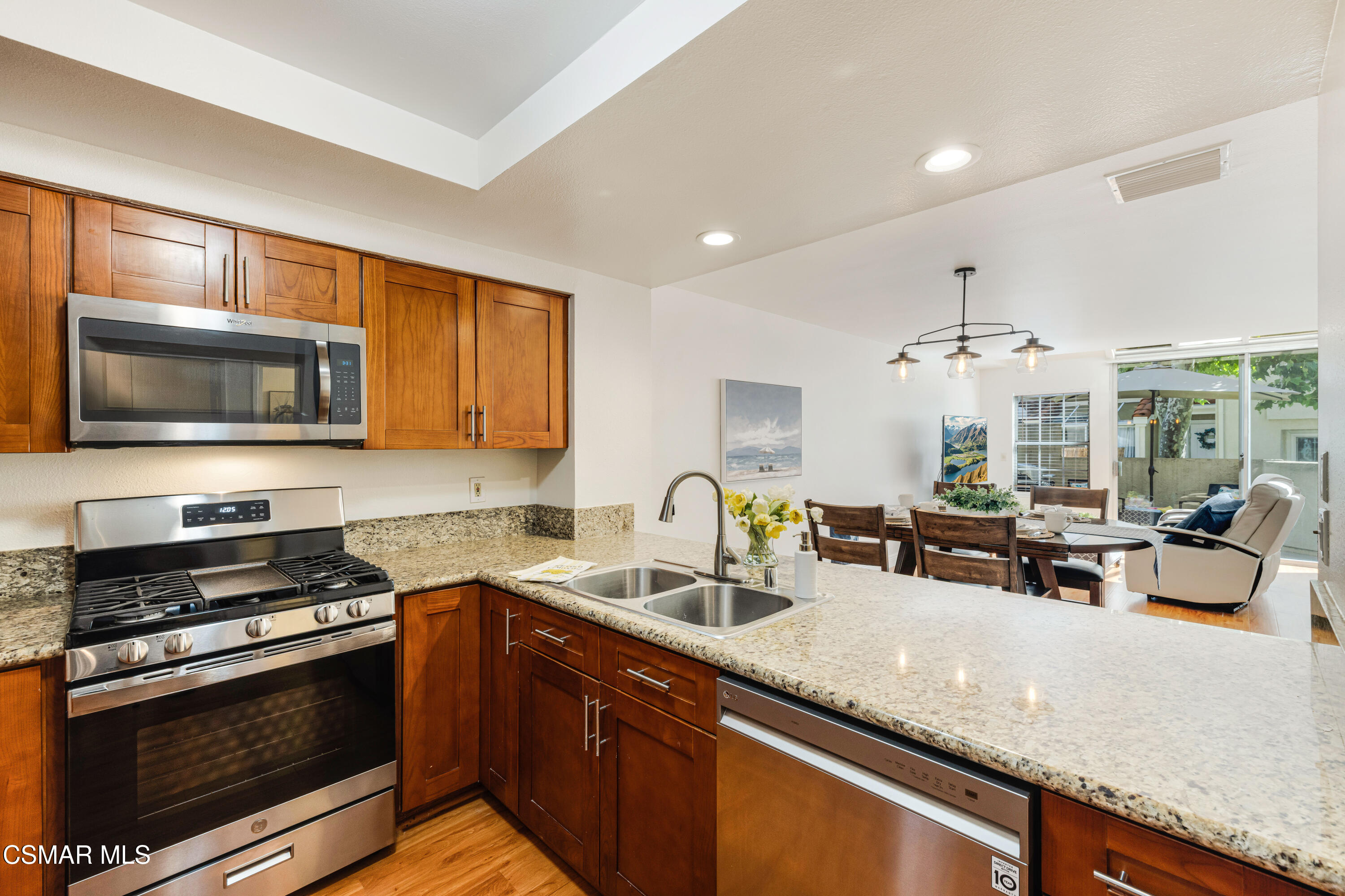 4240 Lost Hills Road, Unit 1902 Calabasas, CA 91301 - Photo 12 of 37 a kitchen with stainless steel appliances granite countertop a sink stove and microwave