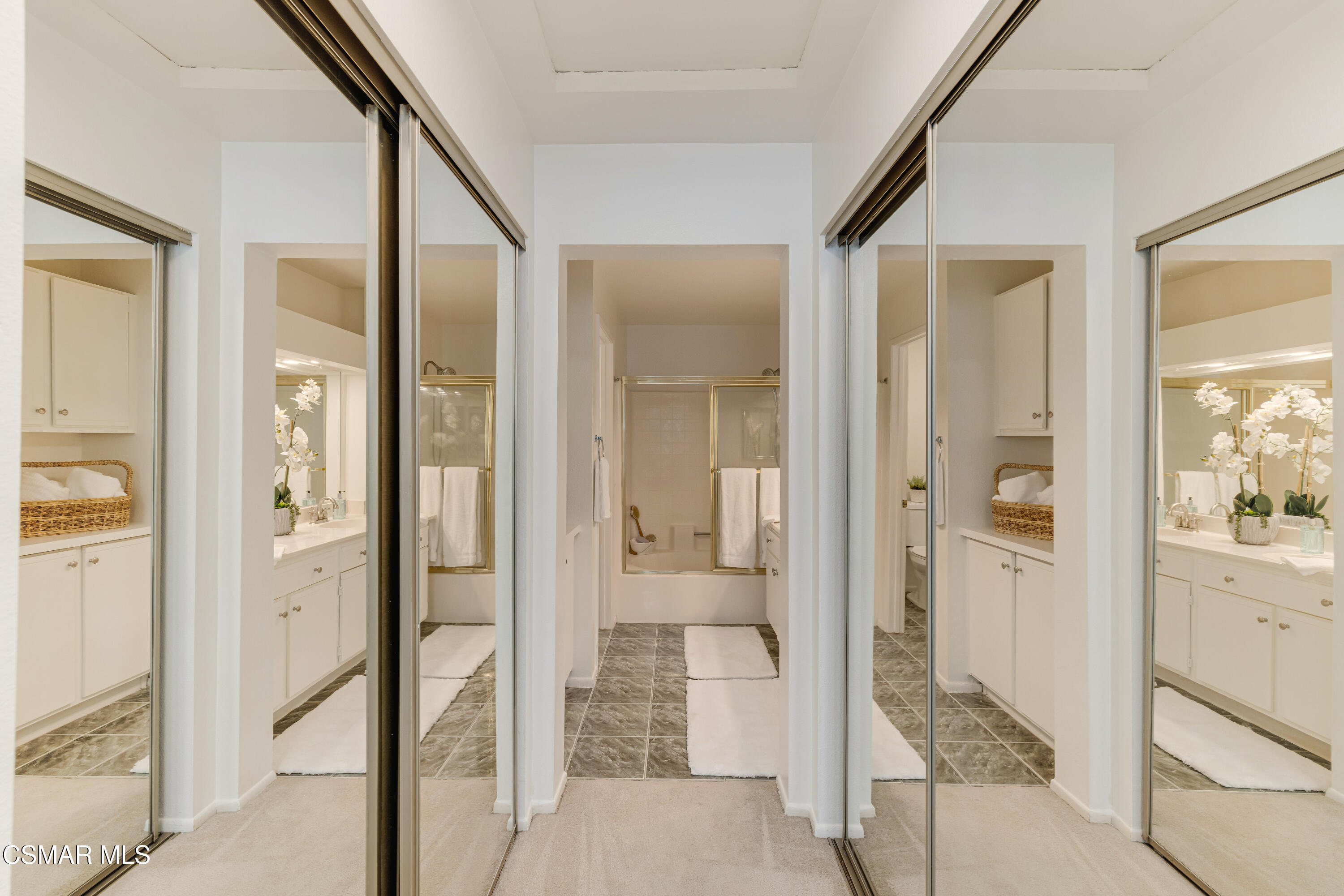4240 Lost Hills Road, Unit 1902 Calabasas, CA 91301 - Photo 21 of 37 a bathroom with a glass shower door and a mirror