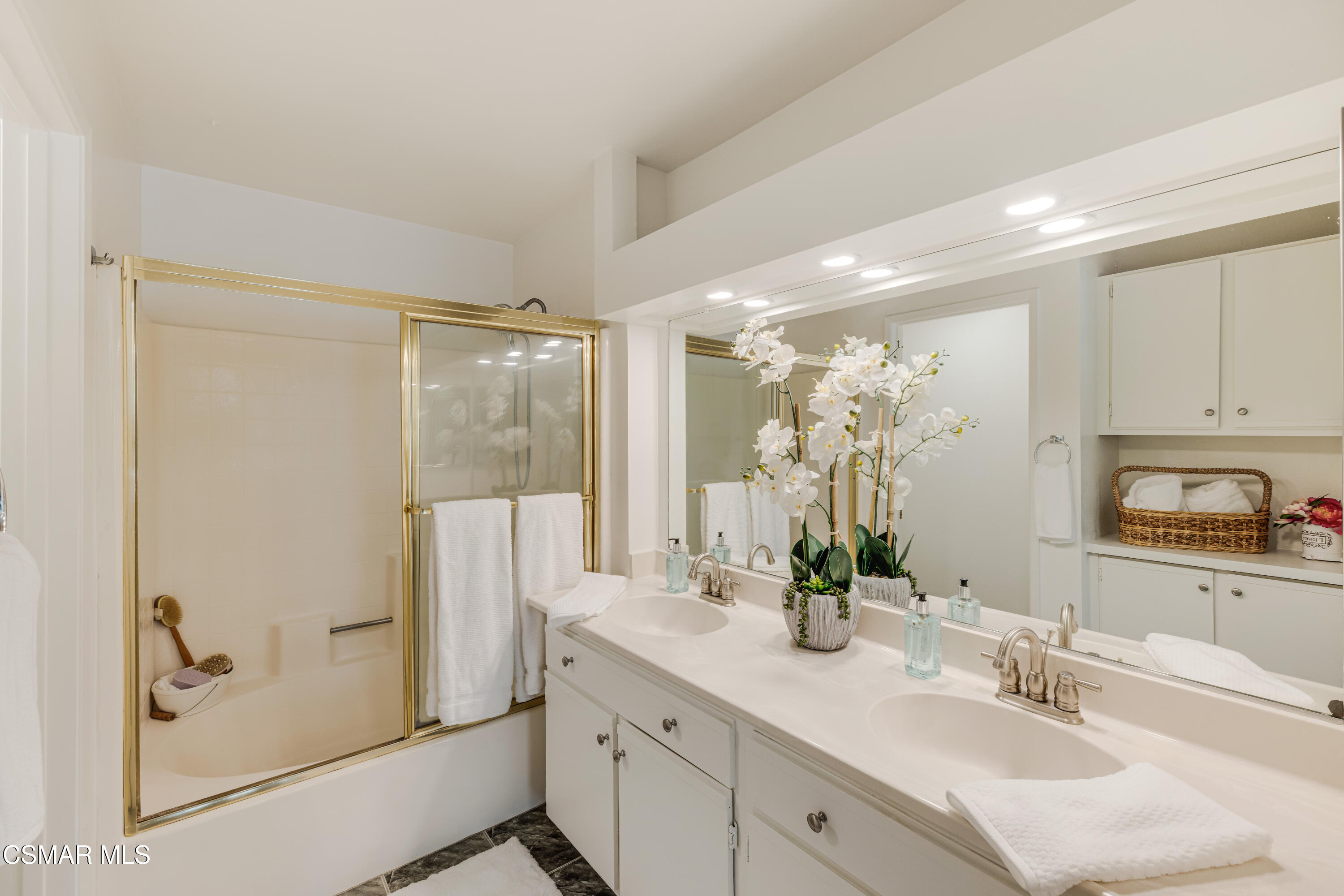 4240 Lost Hills Road, Unit 1902 Calabasas, CA 91301 - Photo 22 of 37 a bathroom with a double vanity sink mirror and shower