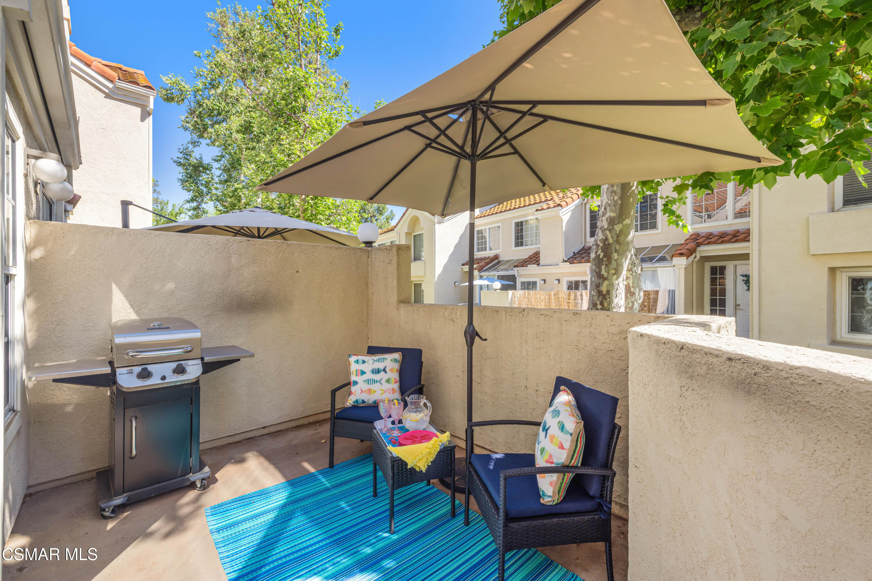 4240 Lost Hills Road, Unit 1902 Calabasas, CA 91301 - Photo 27 of 37 a patio with table and chairs under an umbrella