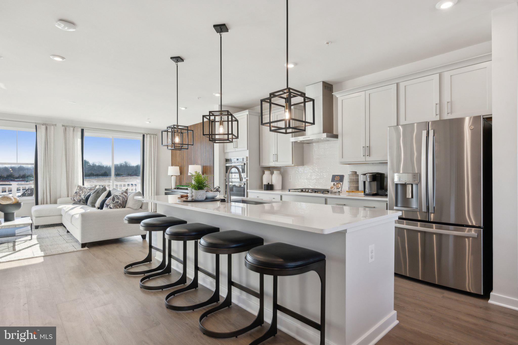 10939 Pinnacle Green Road Upper Marlboro, MD 20772 - Photo 12 of 43 a kitchen with stainless steel appliances granite countertop a sink a stove and chairs