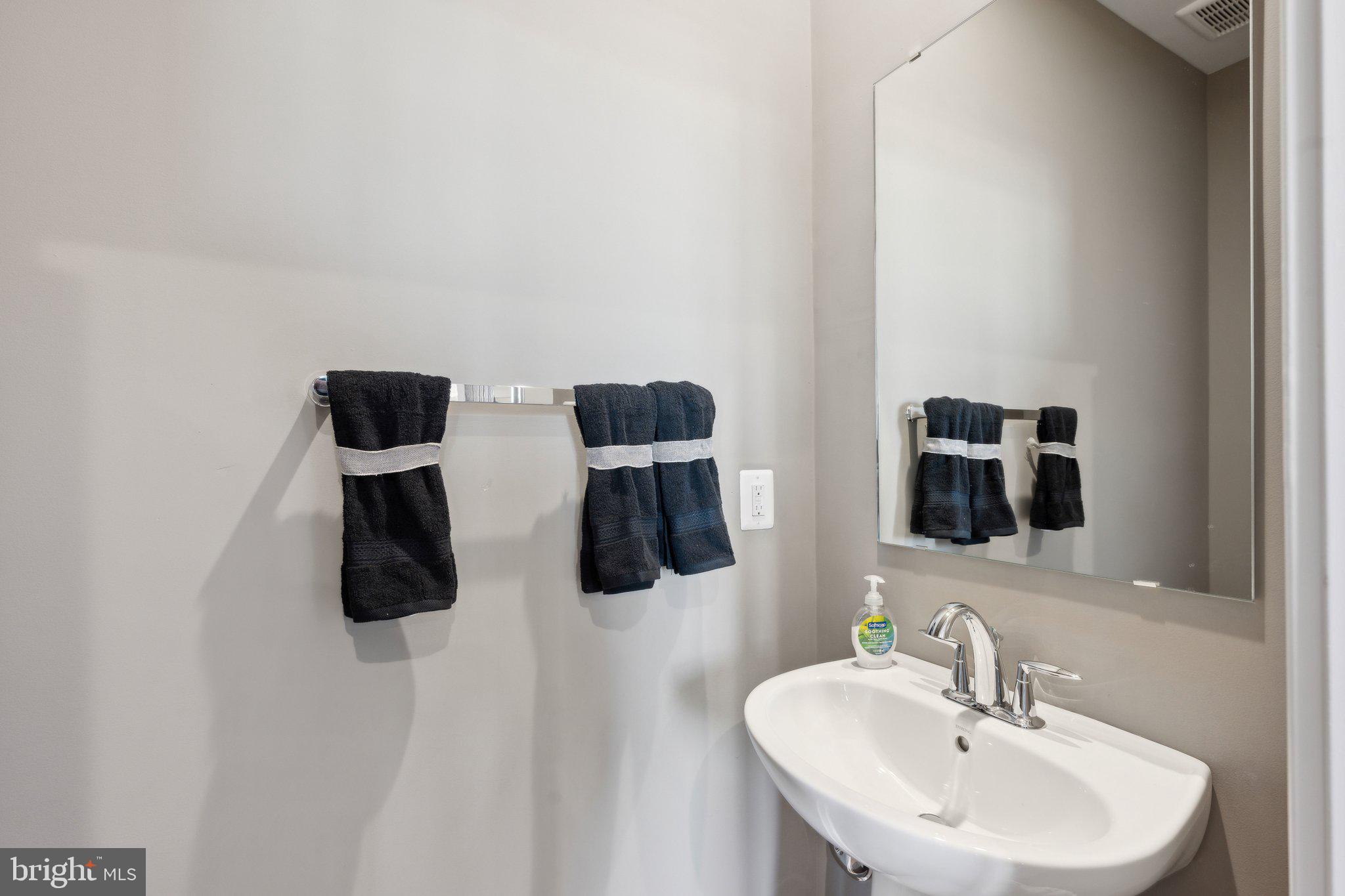 10939 Pinnacle Green Road Upper Marlboro, MD 20772 - Photo 5 of 43 a bathroom with a double vanity sink and mirror