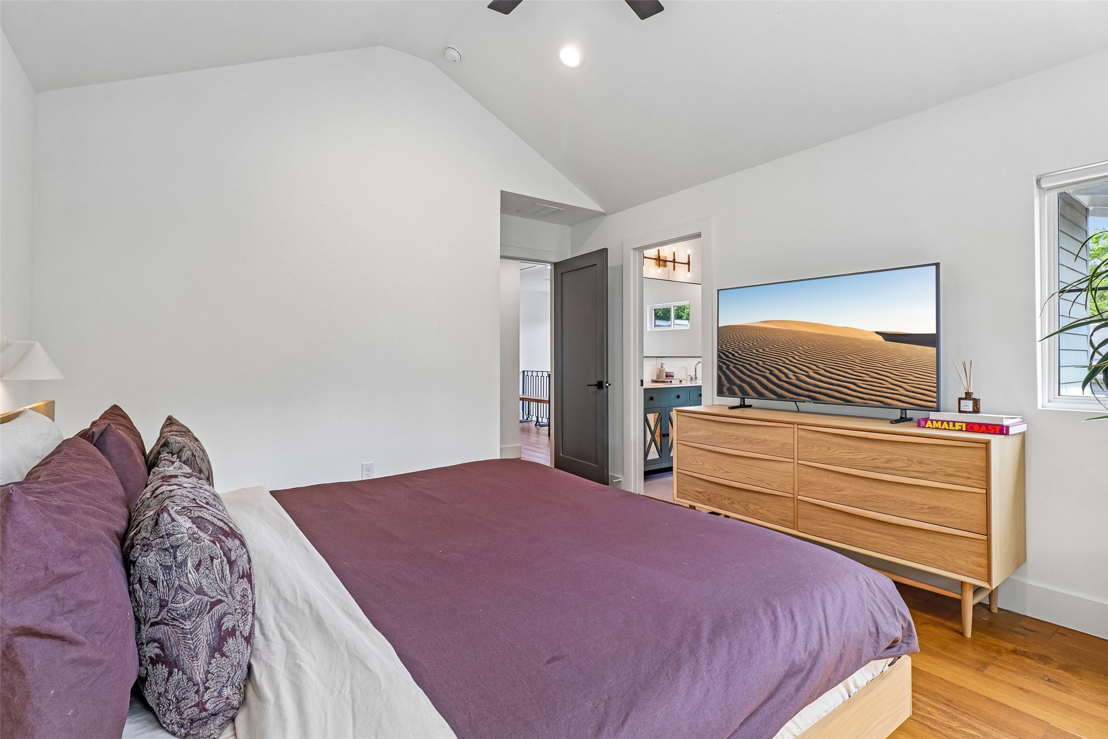 1706 Perez Street, Unit 1 Austin, TX 78721 - Photo 26 of 36 Vast vaulted ceilings create an airy ambiance in this naturally illuminated bedroom.
