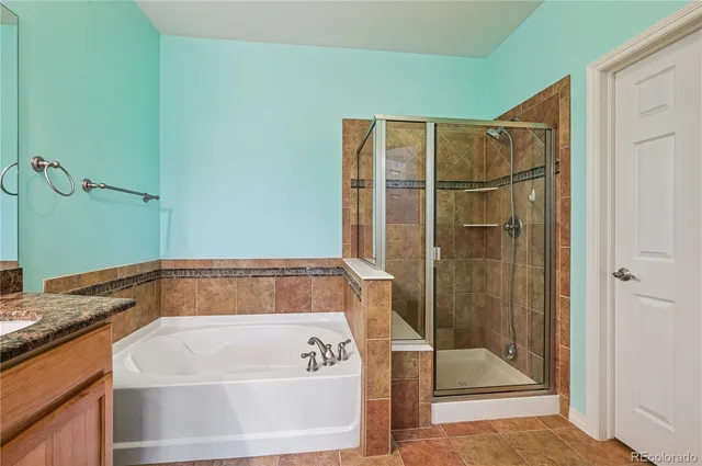 a bathroom with a bath tub and shower