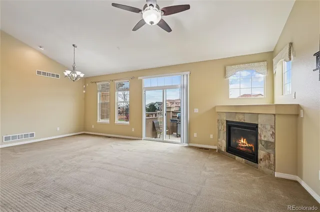 a view of livingroom with fireplace fan and windows