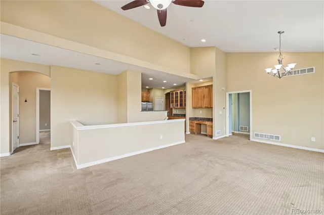 a view of a big room with windows and chandelier