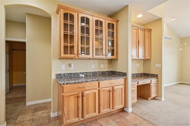 a kitchen with stainless steel appliances granite countertop a stove and a refrigerator