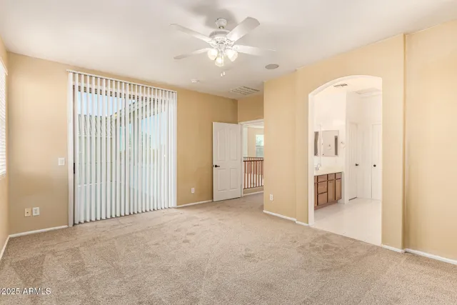 a view of a bedroom with wooden floor & a window