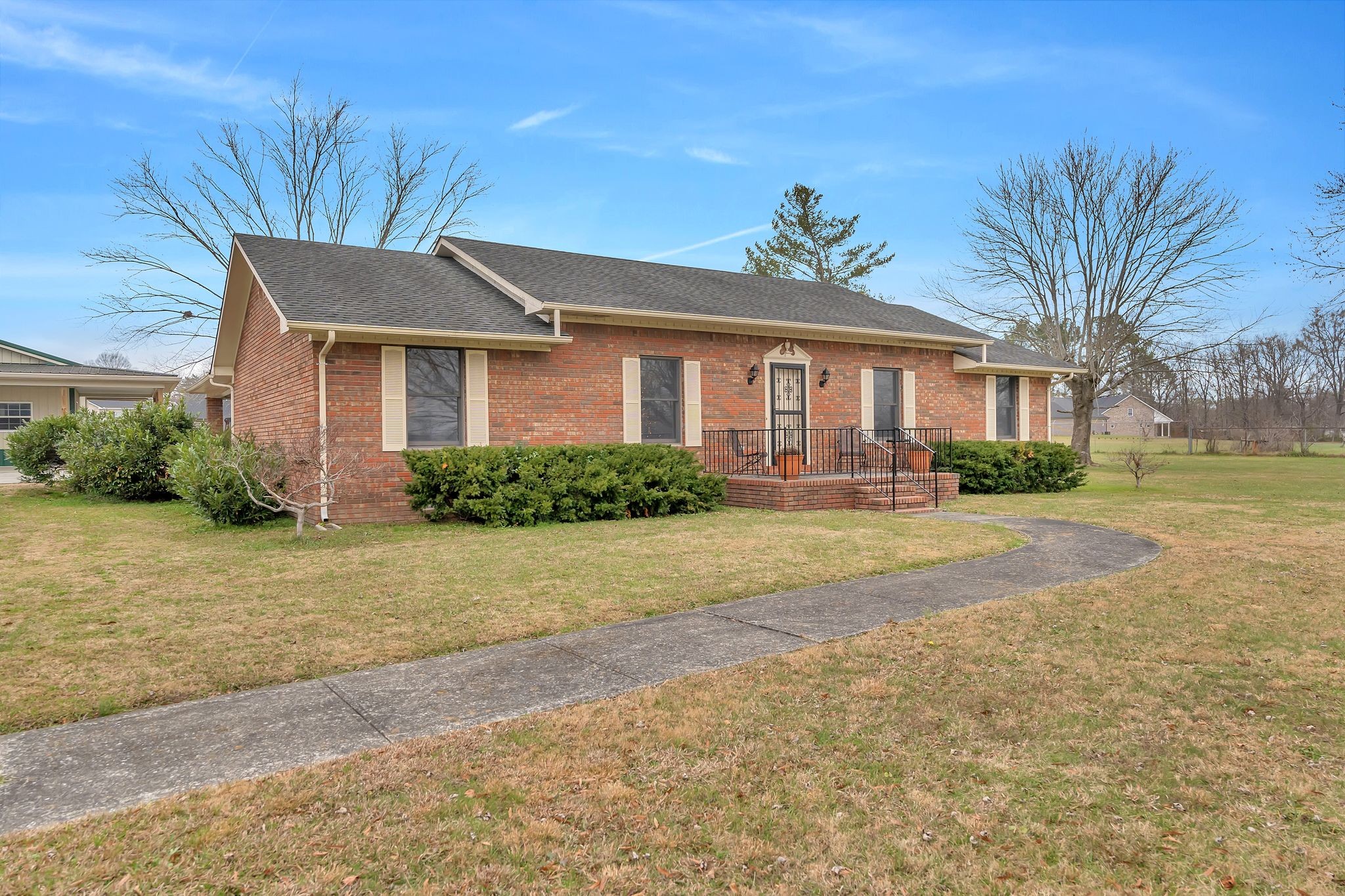 1210 Hills Chapel Road Manchester, TN 37355 - Photo 1 of 33 a front view of a house with a yard and potted plants