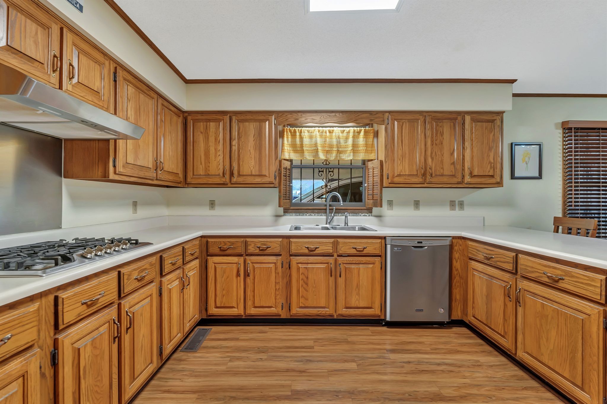 1210 Hills Chapel Road Manchester, TN 37355 - Photo 14 of 33 a kitchen with stainless steel appliances granite countertop a sink stove cabinets and wooden floor