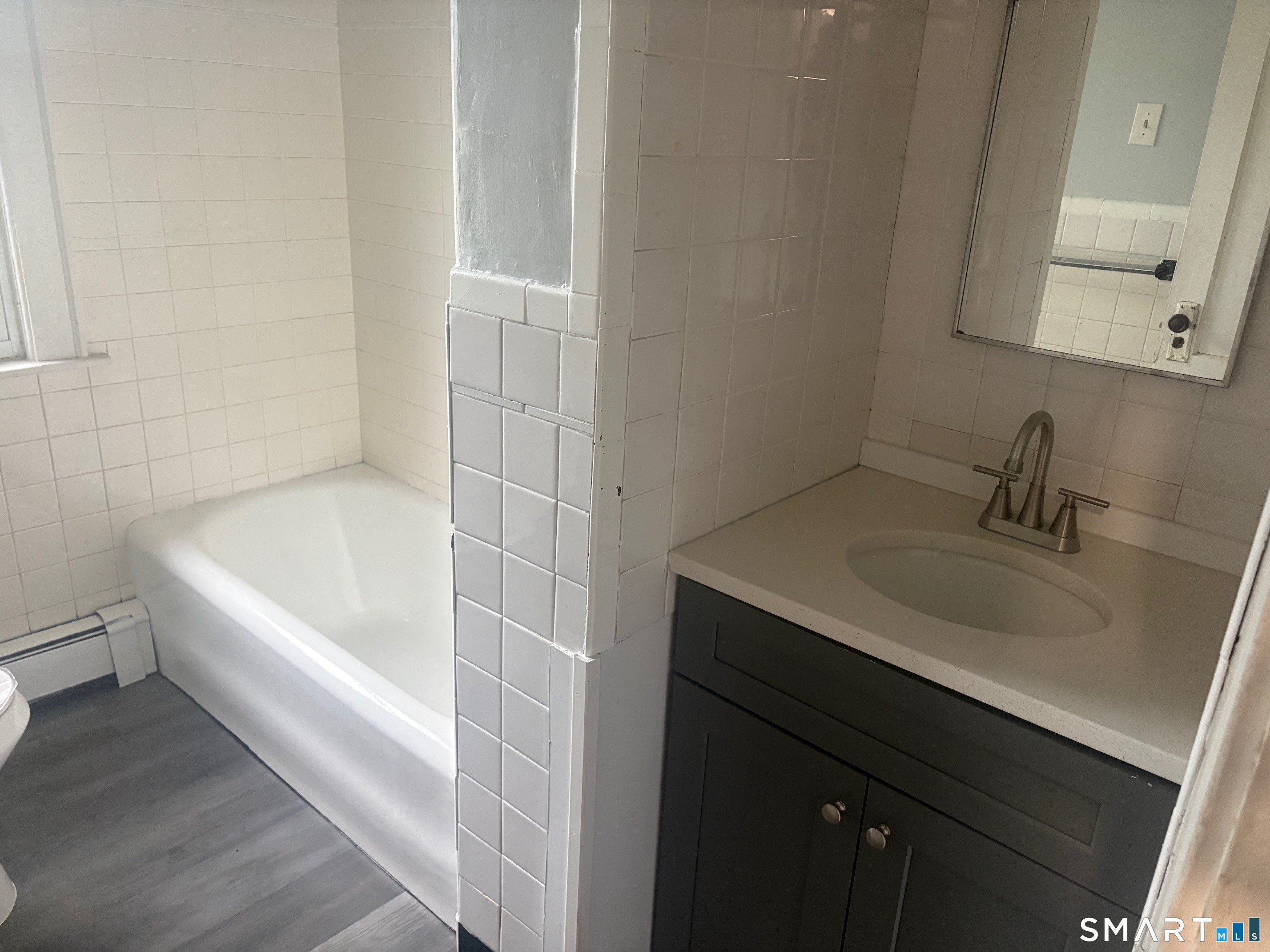 580 High Street Middletown, CT 06457 - Photo 4 of 11 a bathroom with a sink and a bathtub