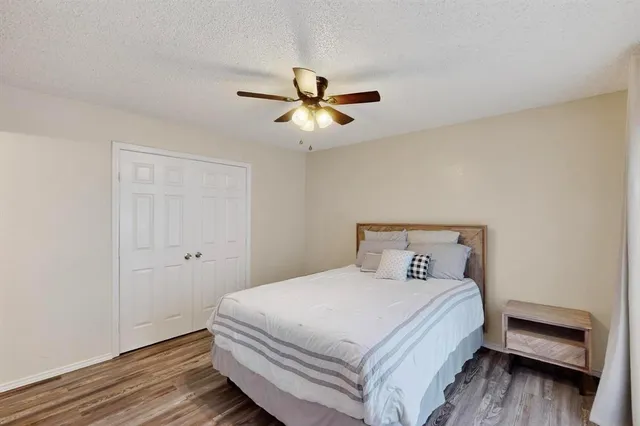 a bedroom with a bed and a ceiling fan