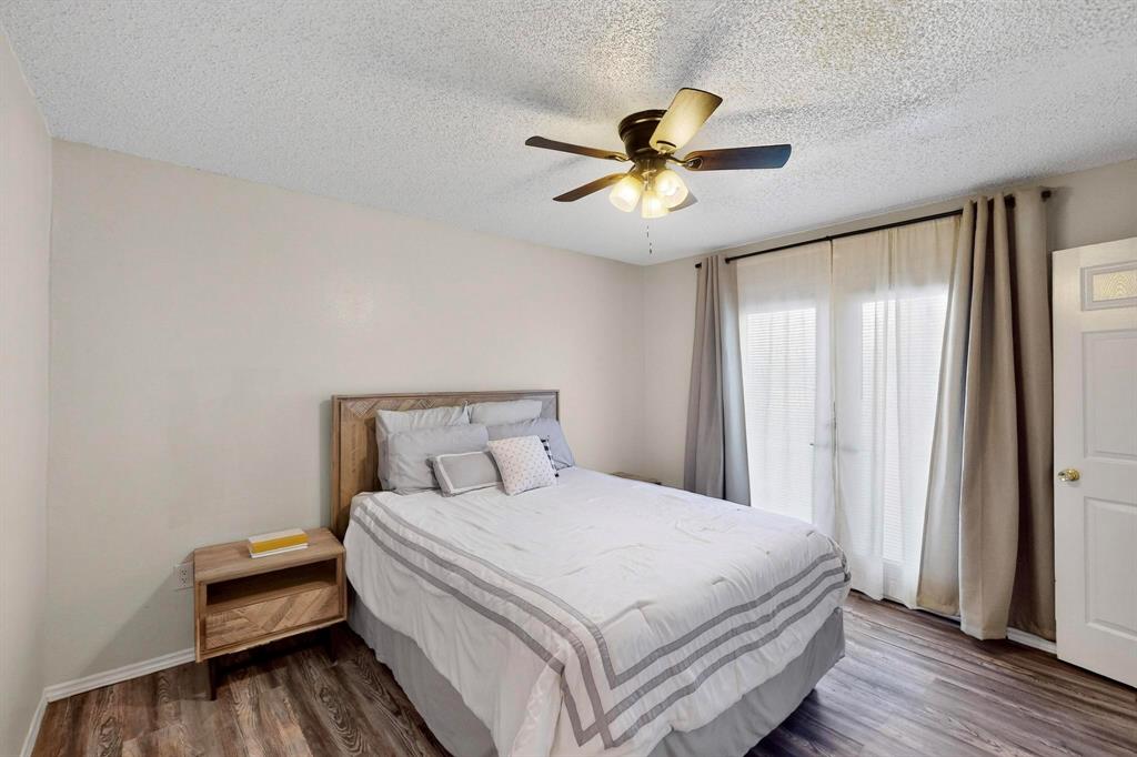 9611 Walnut Street, Unit 1105 Dallas, TX 75081 - Photo 20 of 24 a bedroom with a large bed and a chandelier