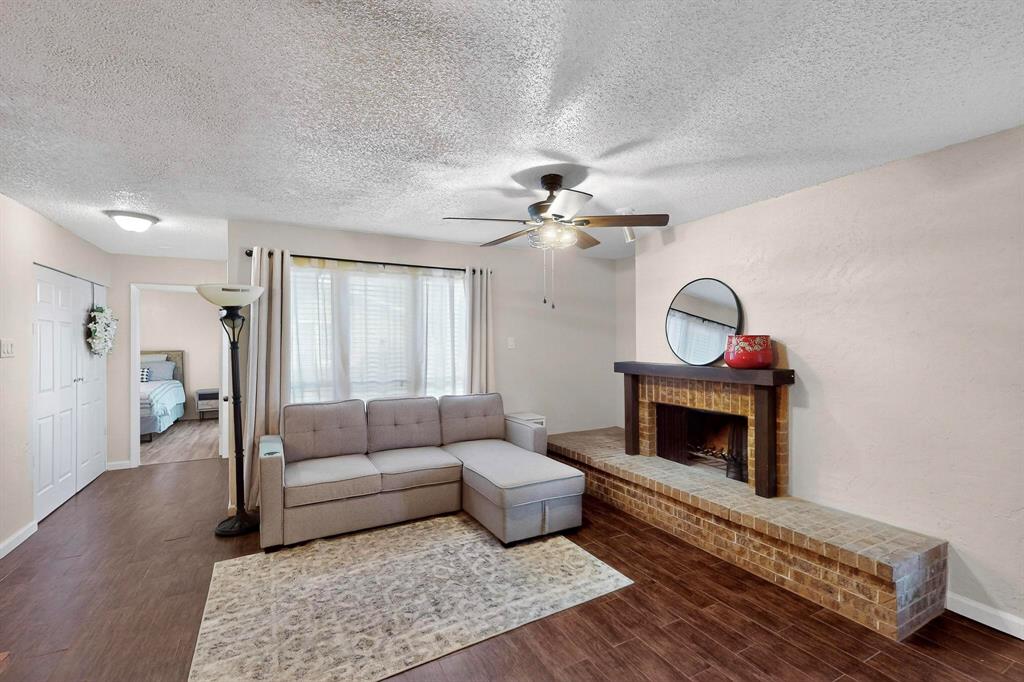 9611 Walnut Street, Unit 1105 Dallas, TX 75081 - Photo 6 of 24 a living room with furniture and a fireplace